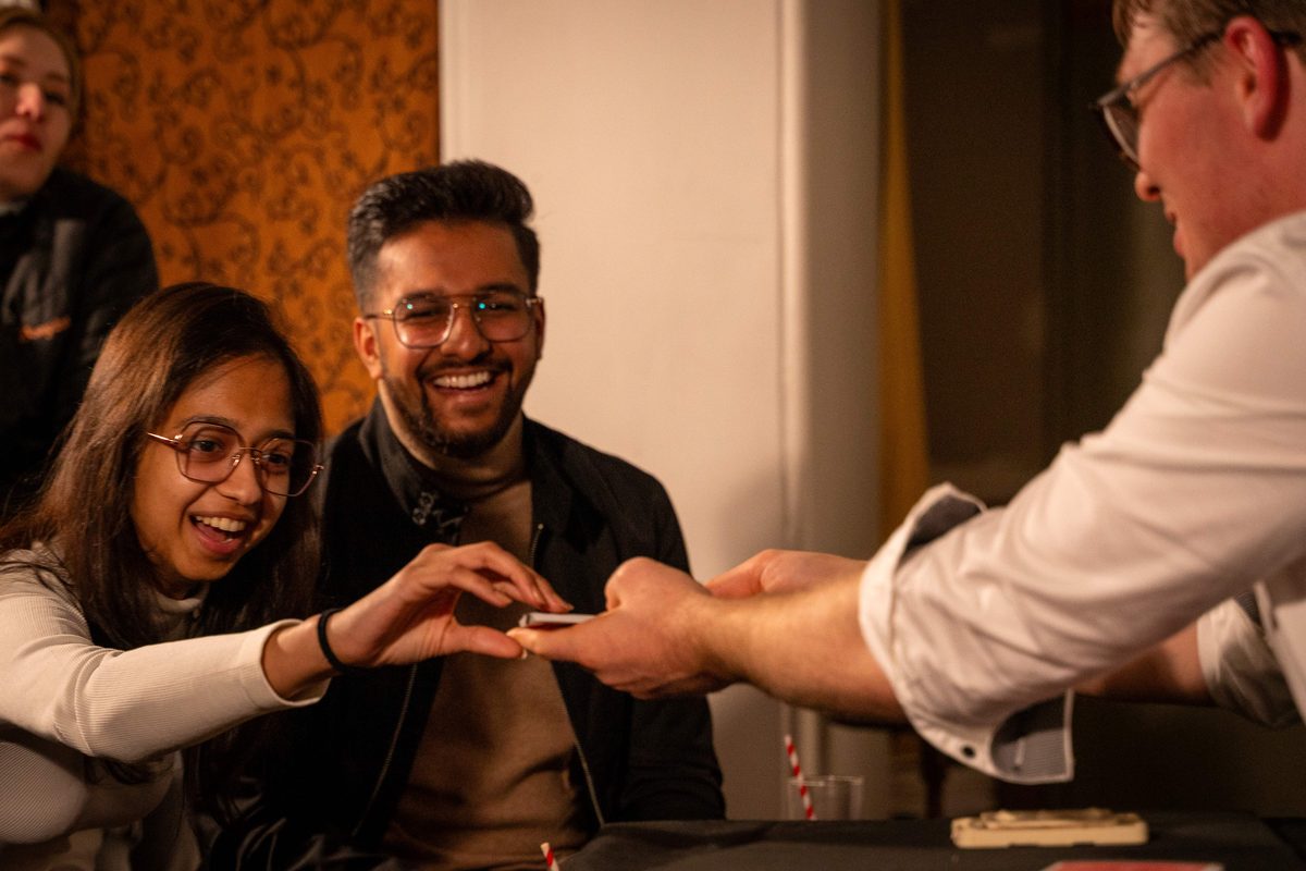 Delighted guests reacting as Sam King performs roving close-up magic